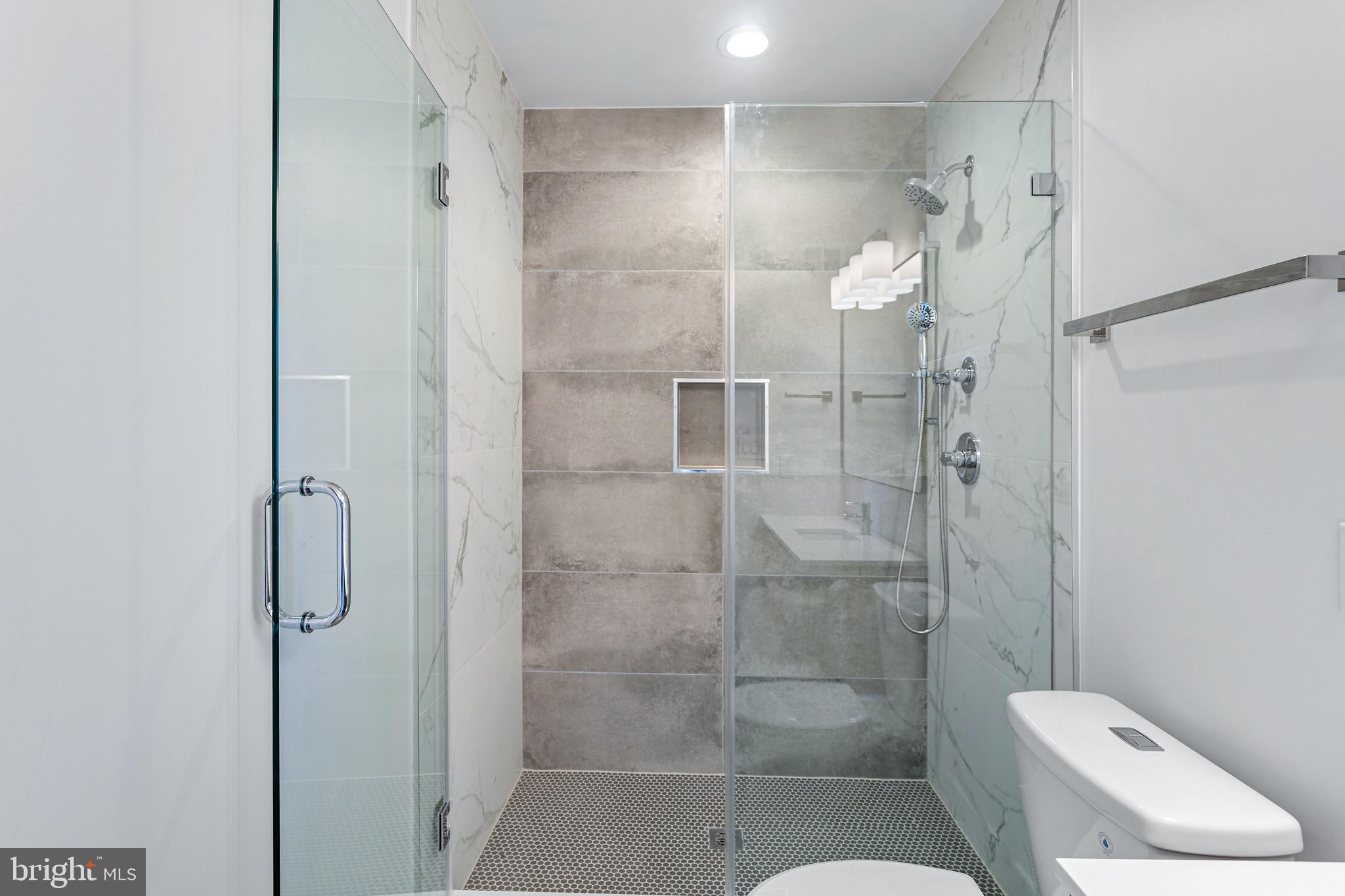 845 19th Street Northeast, Unit PH12 Washington, DC 20002 - Photo 14 of 24 a bathroom with a shower and toilet