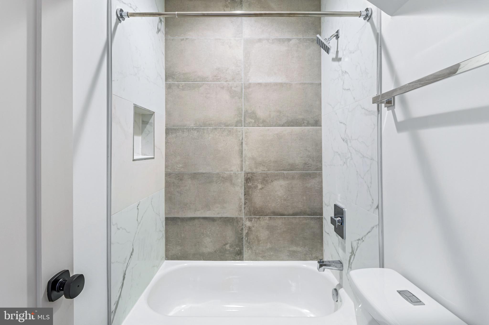 845 19th Street Northeast, Unit PH12 Washington, DC 20002 - Photo 17 of 24 a bathroom with a tub and shower