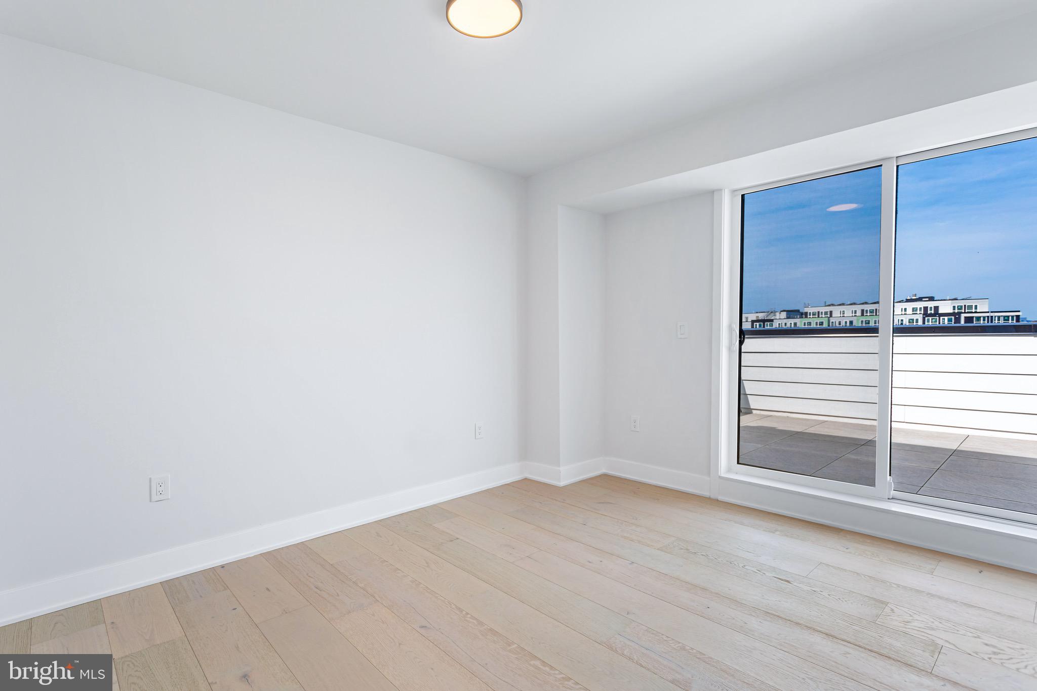 845 19th Street Northeast, Unit PH12 Washington, DC 20002 - Photo 8 of 24 a view of empty room with wooden floor and fan