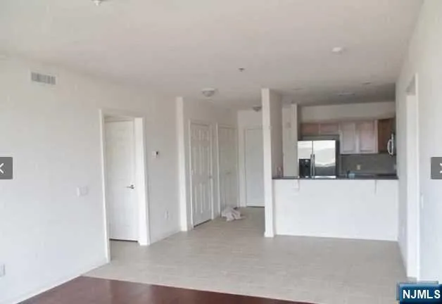 a kitchen with granite countertop a refrigerator and a sink