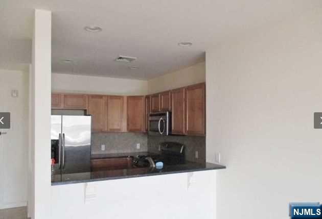 380-382 Anderson Avenue, Unit C1 Cliffside Park, NJ 07010 - Photo 13 of 17 a kitchen with granite countertop a refrigerator and a sink
