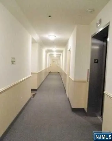 a kitchen with granite countertop a stove sink and microwave