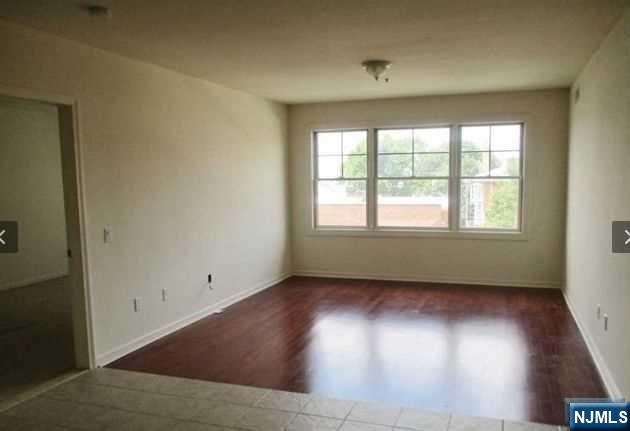 380-382 Anderson Avenue, Unit C1 Cliffside Park, NJ 07010 - Photo 8 of 17 an empty room with wooden floor and windows