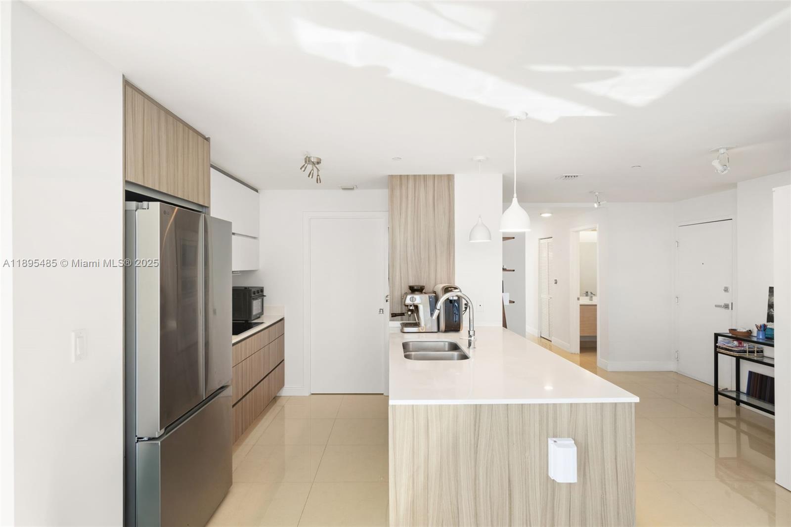 600 Northeast 27th Street, Unit 3105 Miami, FL 33137 - Photo 11 of 61 a kitchen with kitchen island a refrigerator sink and stove