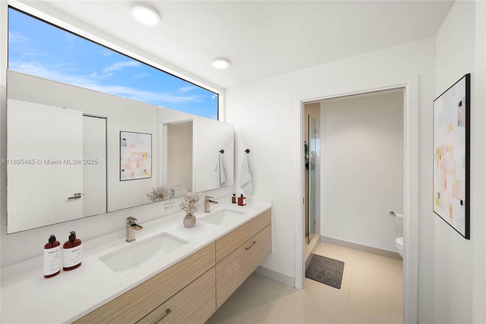 600 Northeast 27th Street, Unit 3105 Miami, FL 33137 - Photo 17 of 61 a bathroom with a double vanity sink mirror and