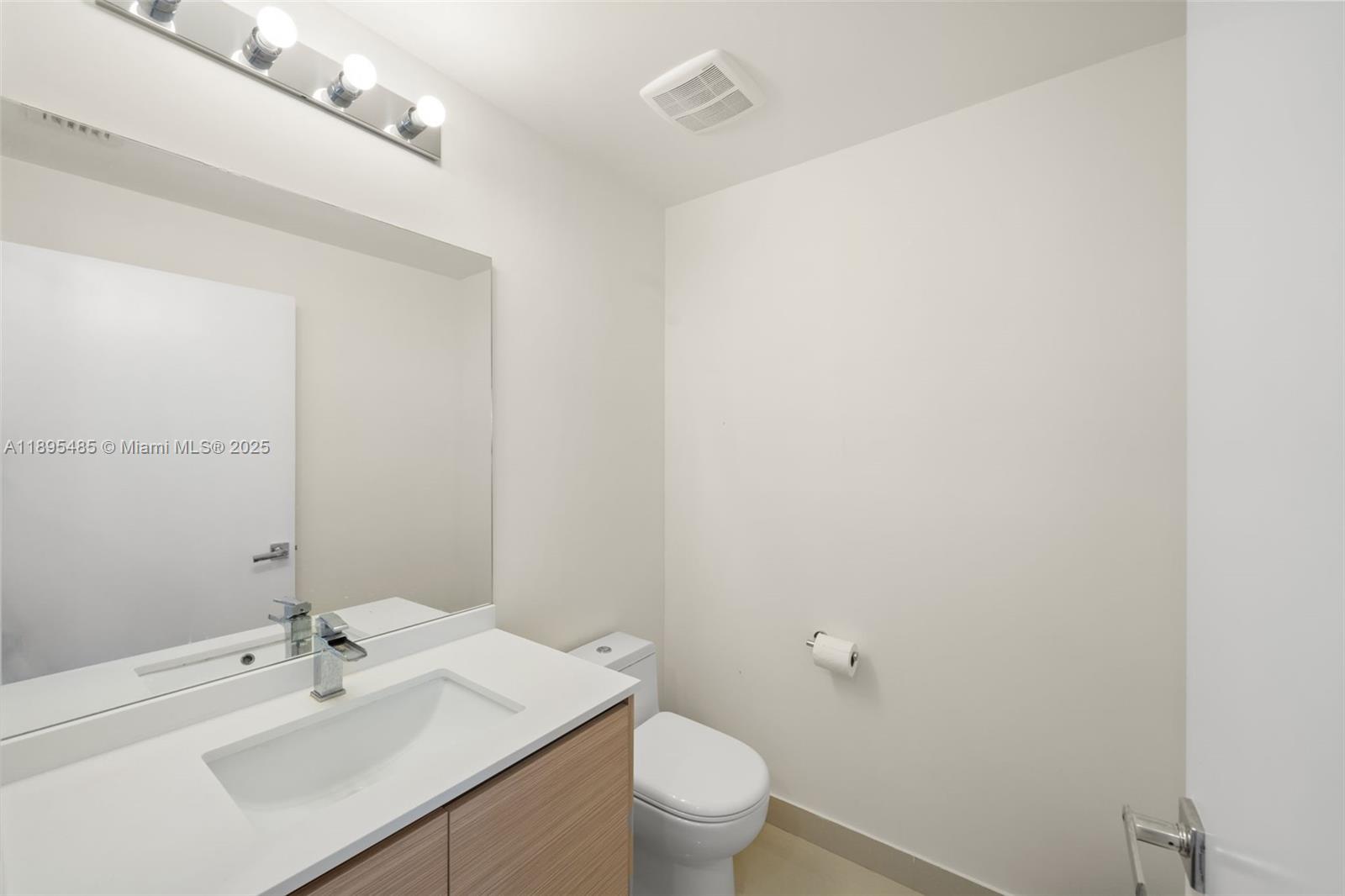 600 Northeast 27th Street, Unit 3105 Miami, FL 33137 - Photo 27 of 61 a bathroom with a sink a toilet and a mirror