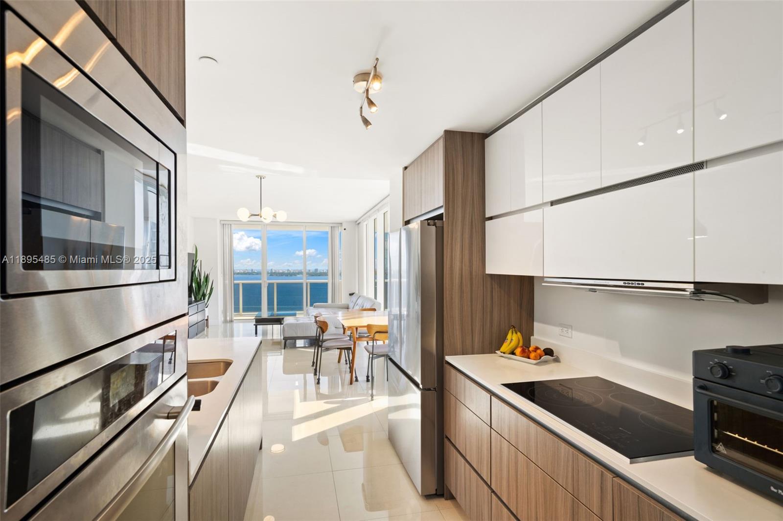 600 Northeast 27th Street, Unit 3105 Miami, FL 33137 - Photo 10 of 61 a kitchen with stainless steel appliances sink stove and cabinets
