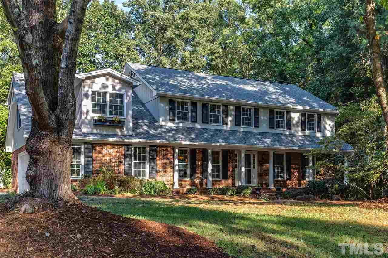 8713 Cliff Top Court Raleigh, NC 27613 - Photo 1 of 25 a front view of a house with a yard garden and outdoor seating