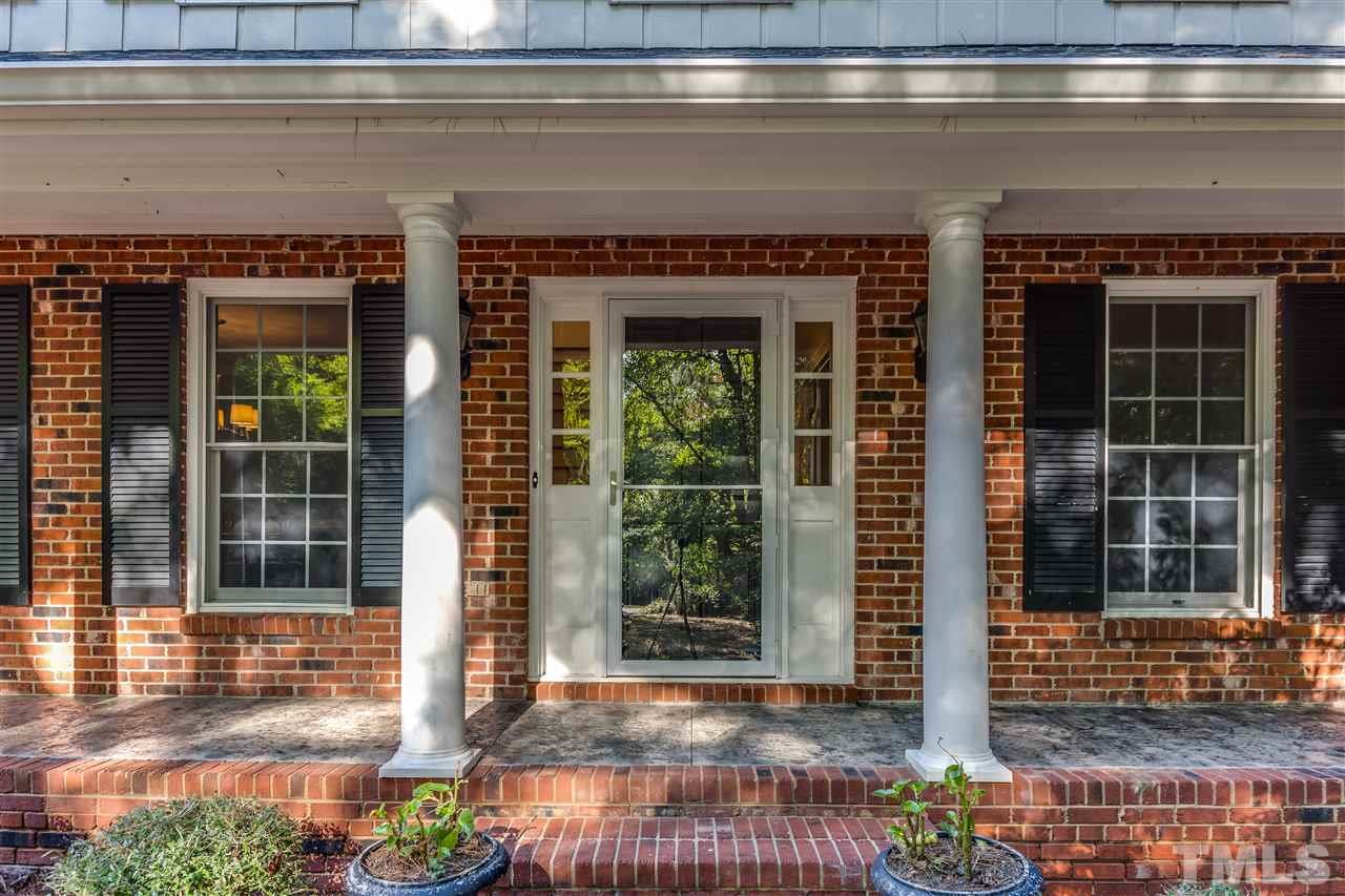 8713 Cliff Top Court Raleigh, NC 27613 - Photo 2 of 25 a front view of a house with a porch