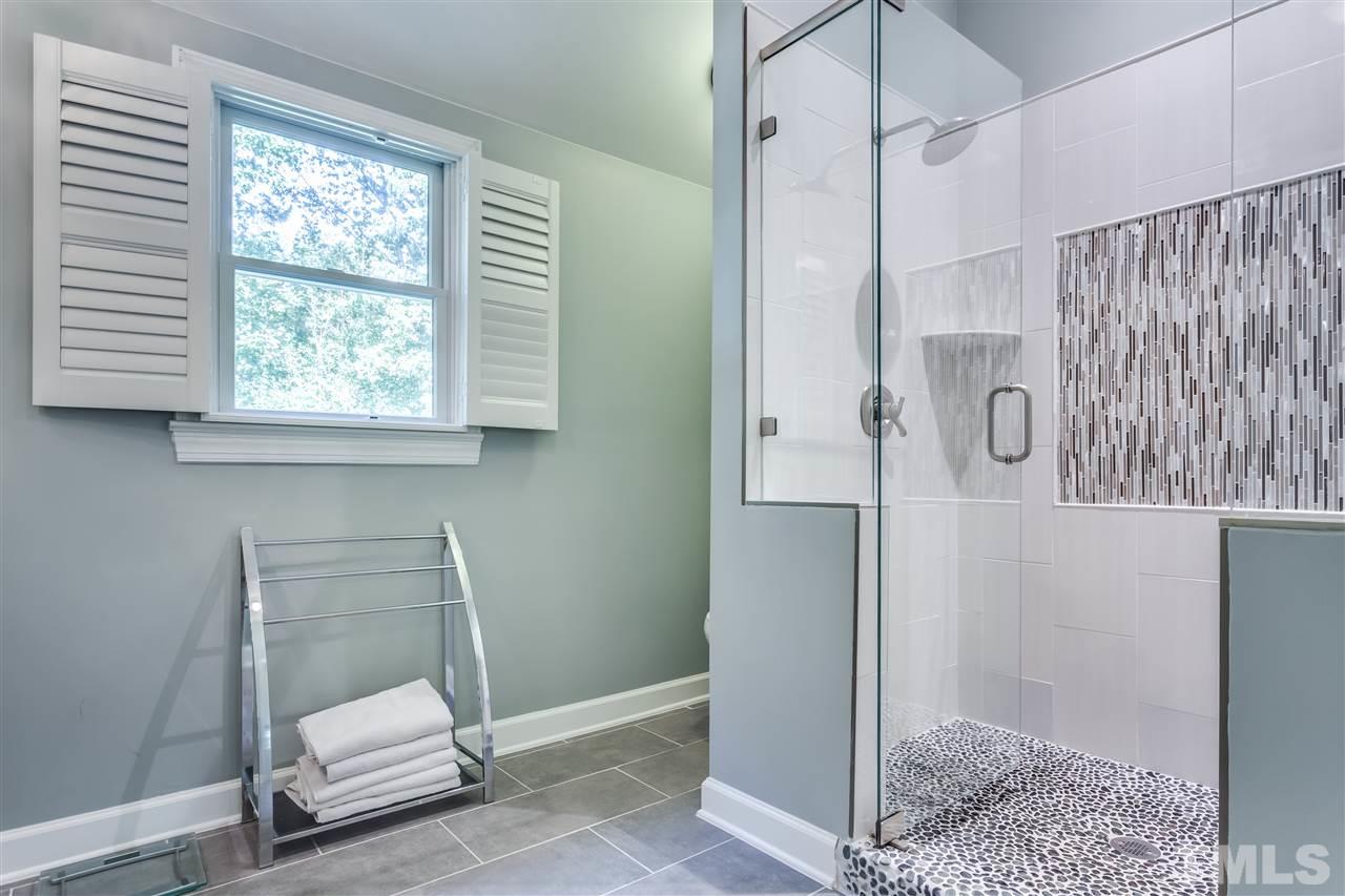 8713 Cliff Top Court Raleigh, NC 27613 - Photo 17 of 25 a bathroom with a shower