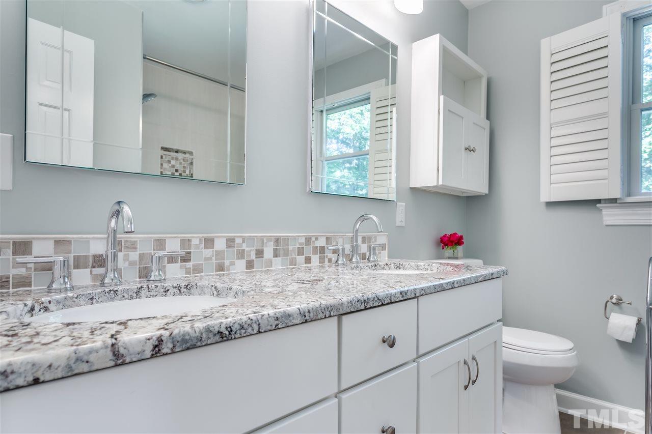 8713 Cliff Top Court Raleigh, NC 27613 - Photo 19 of 25 a kitchen with granite countertop a sink a stove and cabinets