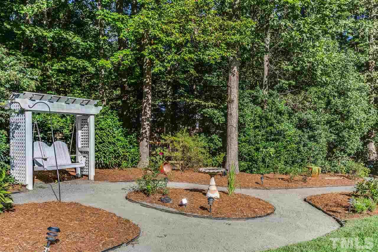 8713 Cliff Top Court Raleigh, NC 27613 - Photo 20 of 25 a view of a patio with a table and chairs