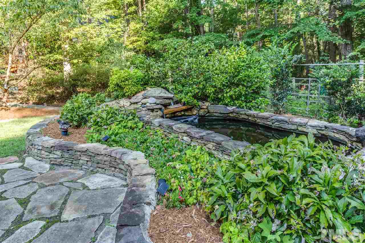 8713 Cliff Top Court Raleigh, NC 27613 - Photo 21 of 25 a view of a garden with a tree