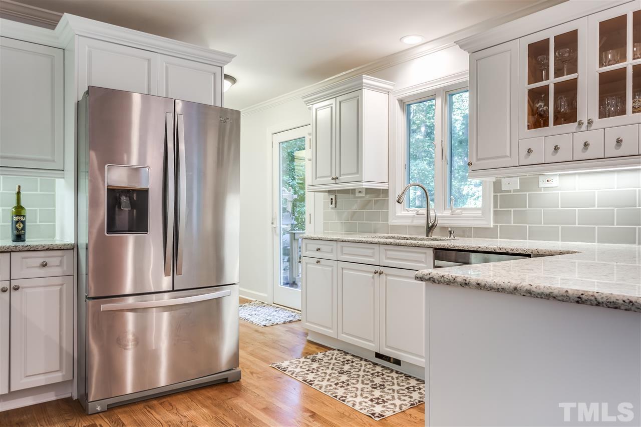 8713 Cliff Top Court Raleigh, NC 27613 - Photo 5 of 25 a kitchen with stainless steel appliances granite countertop a refrigerator a sink and white cabinets