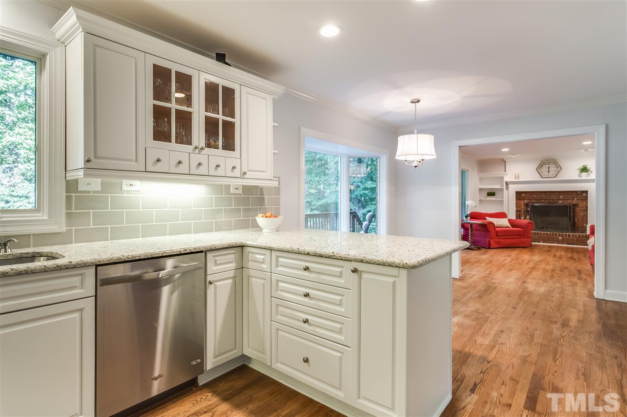 8713 Cliff Top Court Raleigh, NC 27613 - Photo 7 of 25 a kitchen that has a lot of cabinets in it and wooden floors