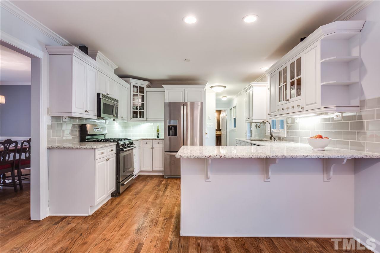 8713 Cliff Top Court Raleigh, NC 27613 - Photo 8 of 25 a kitchen with stainless steel appliances a sink and a refrigerator