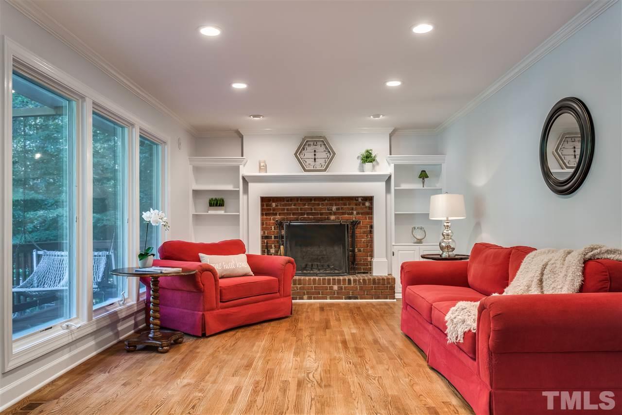8713 Cliff Top Court Raleigh, NC 27613 - Photo 10 of 25 a living room with furniture a large window and a fireplace