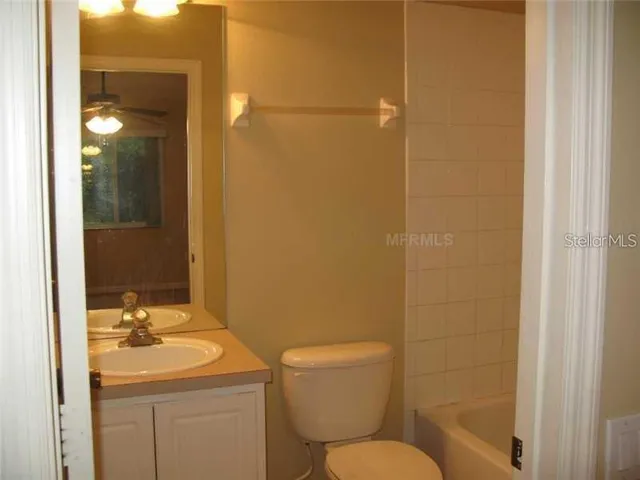a bathroom with a sink mirror toilet and shower