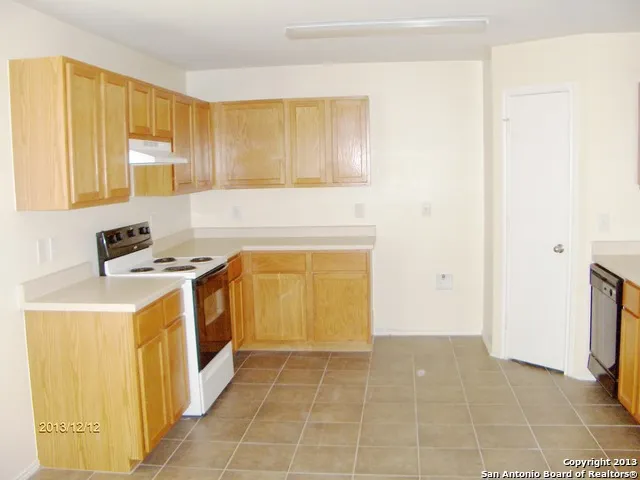 a view of an empty room and a window