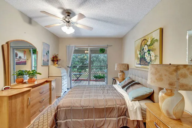 a bed room with a bed and a large window