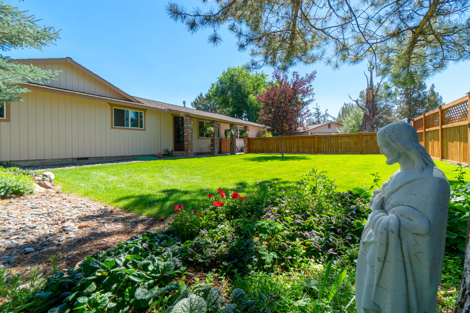 2218 Southwest 79th Street Redmond, OR 97756 - Photo 38 of 54 a view of a backyard with plants and large tree