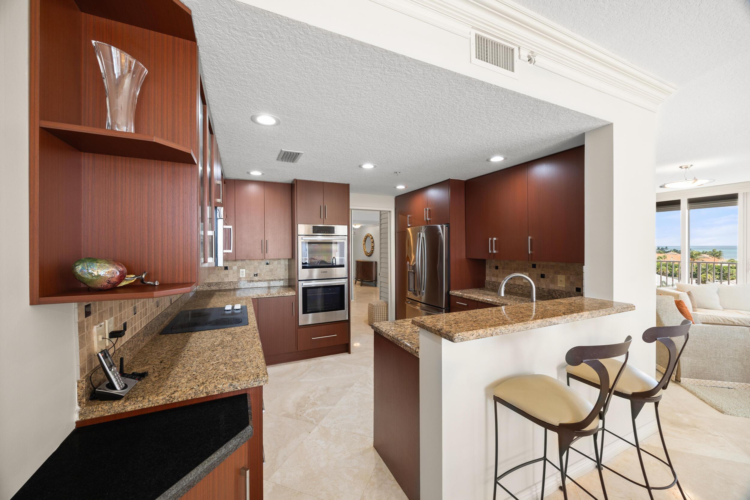 700 Ocean Royale, Unit 601 Juno Beach, FL 33408 - Photo 13 of 56 a kitchen with a sink a counter top stainless steel appliances and cabinets