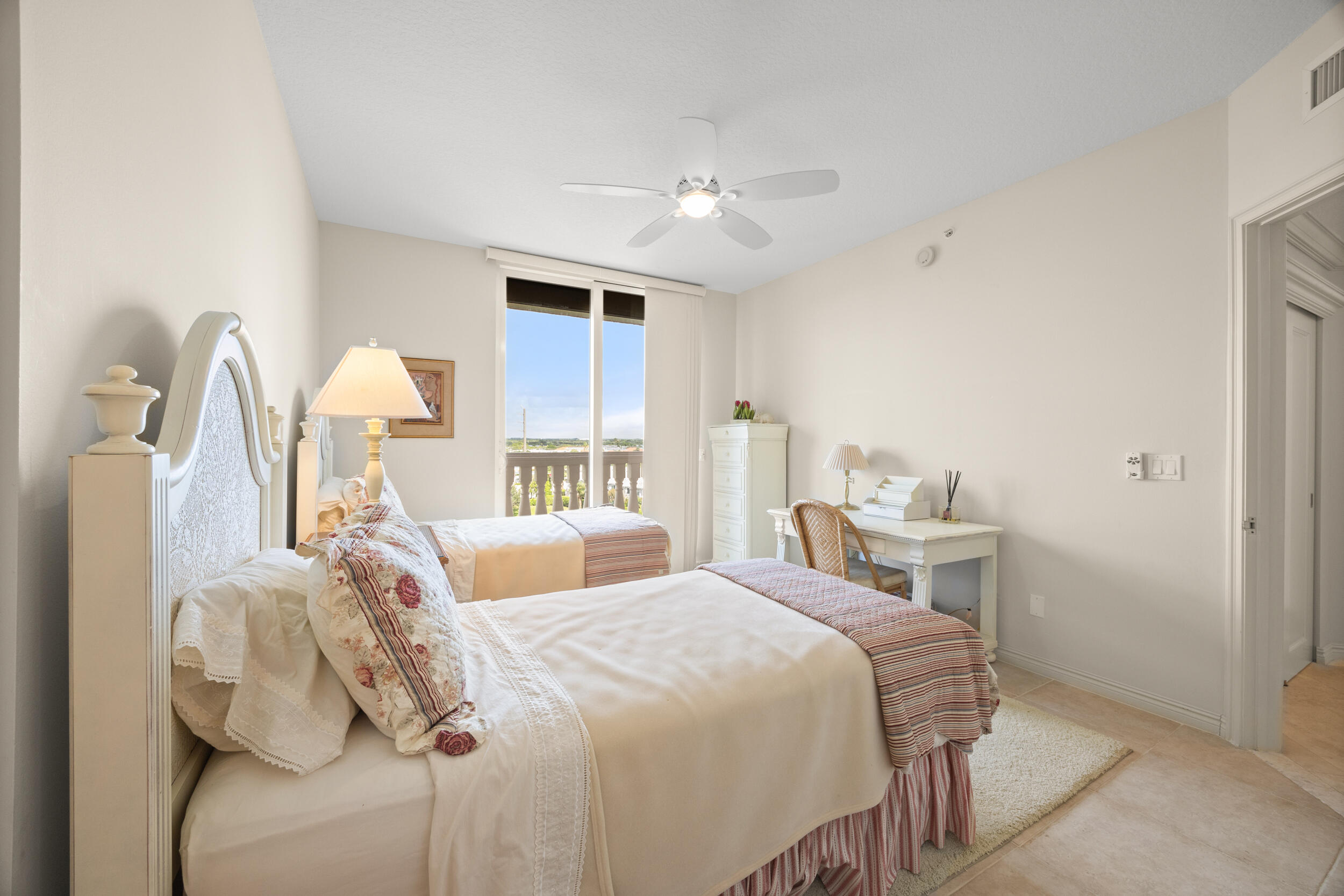 700 Ocean Royale, Unit 601 Juno Beach, FL 33408 - Photo 33 of 56 a bedroom with two beds and a chandelier