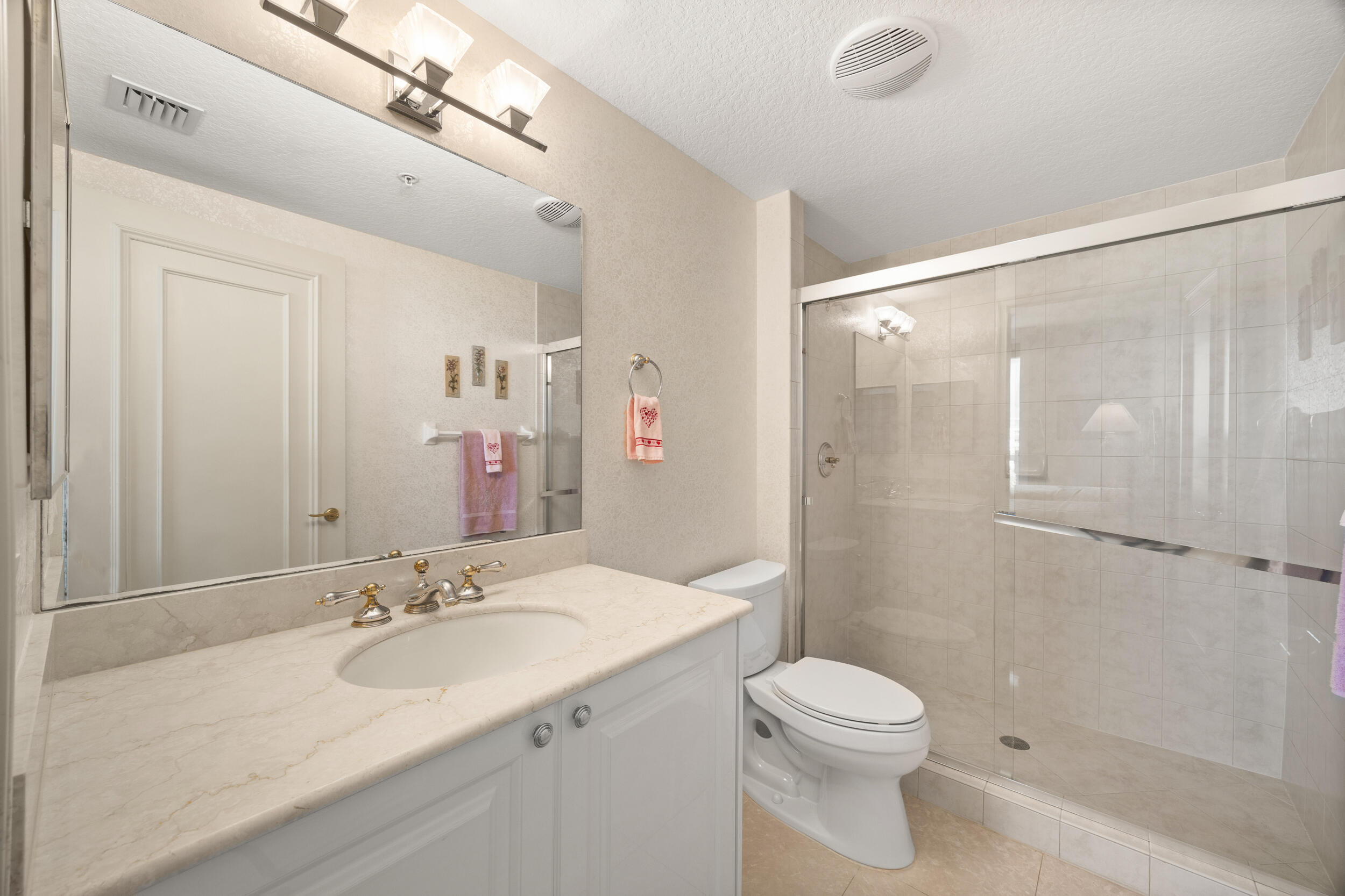 700 Ocean Royale, Unit 601 Juno Beach, FL 33408 - Photo 35 of 56 a bathroom with a sink toilet and shower