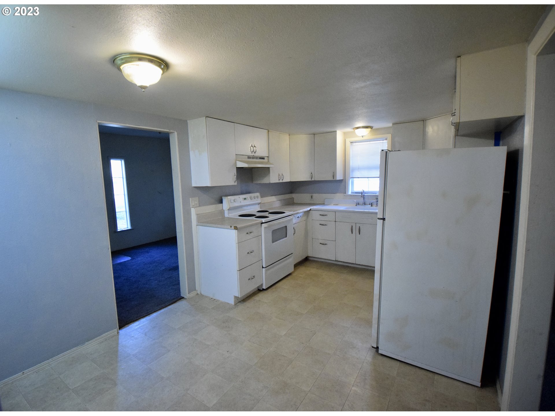 304 Southeast Boulevard Way Estacada, OR 97023 - Photo 5 of 15 a kitchen with a refrigerator sink and cabinets