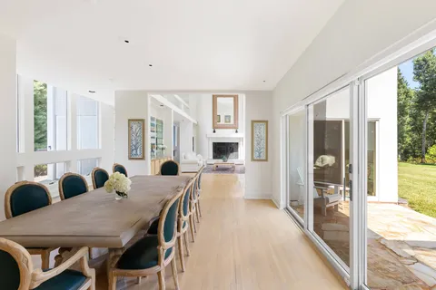 a view of a a dining room with furniture window and wooden floor