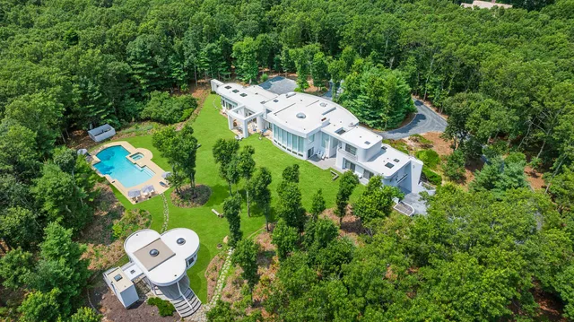 an aerial view of a house with a yard basket ball court and outdoor seating