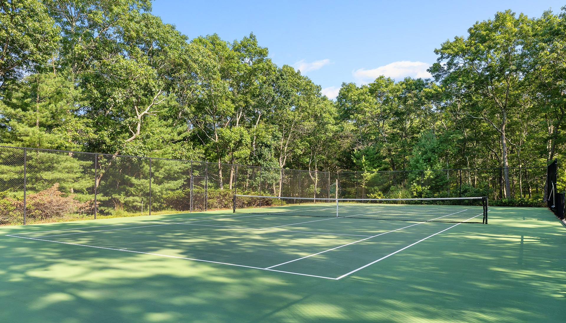 147 Old Northwest Road East Hampton, NY 11937 - Photo 40 of 45 a view of a tennis ground with large trees