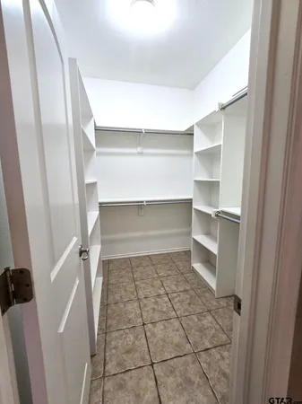 a view of staircase with white walls and a window