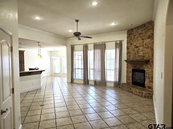 a view of a hallway with furniture and a fireplace