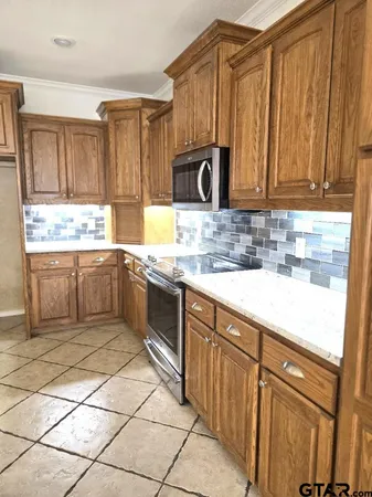 a kitchen with a sink cabinets and window