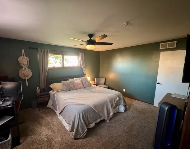 a bedroom with a bed and window