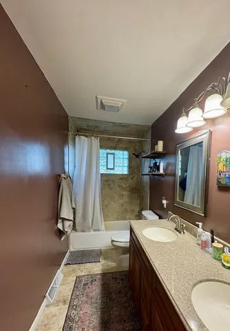 a bathroom with a granite countertop sink mirror and vanity