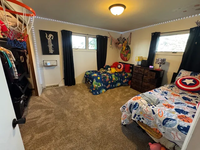 a bedroom with bed and a window