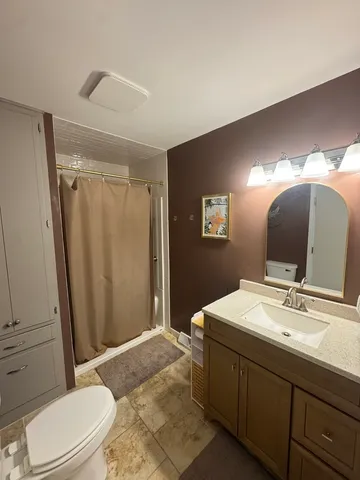 a bathroom with a sink toilet and shower