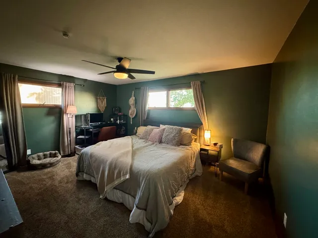 a bedroom with a bed and a mirror