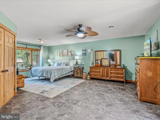 a bedroom with furniture and a chandelier