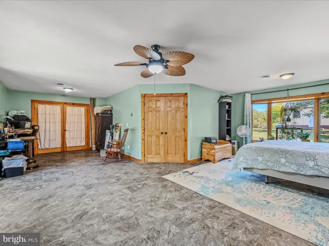 a living room with furniture windows and a flat screen tv