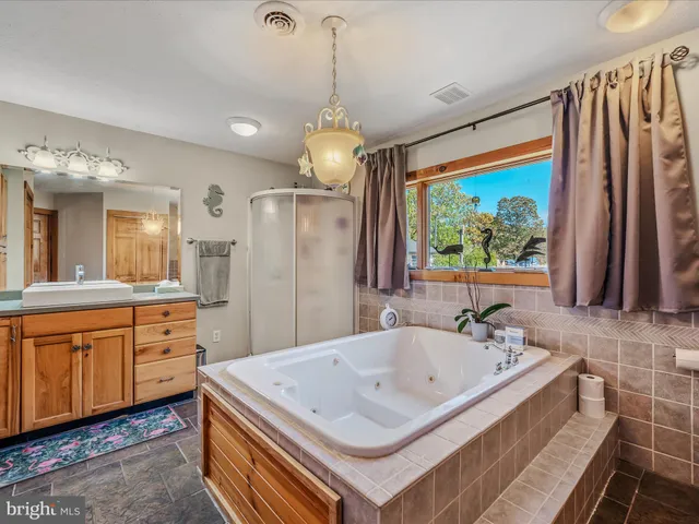 a bathroom with a sink a faucet a mirror and a bathtub