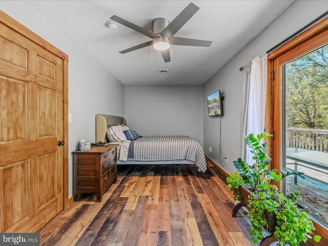 a spacious bedroom with a bed and a window