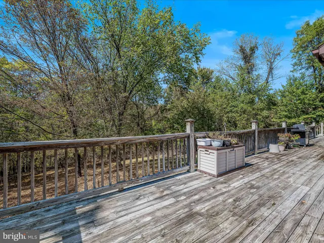 a balcony with wooden floor and fence