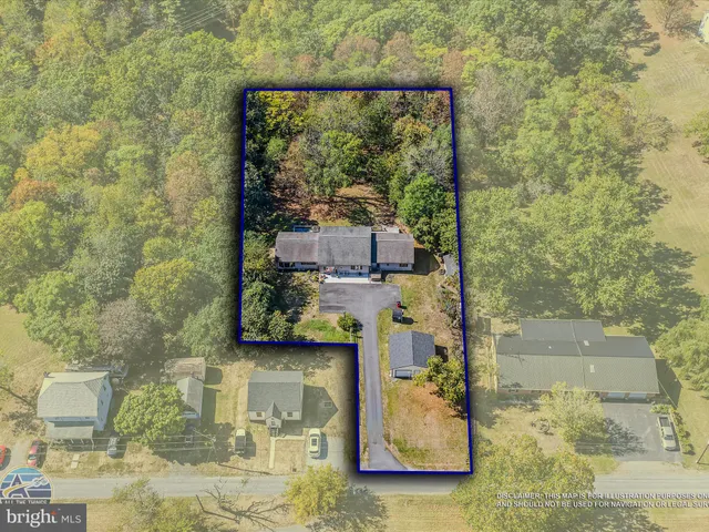 an aerial view of a house with a yard and lake view