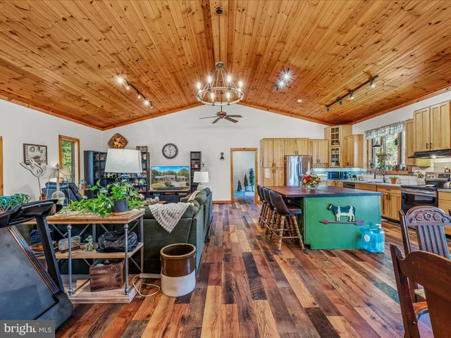 a view of a dining room with furniture kitchen and wooden floor