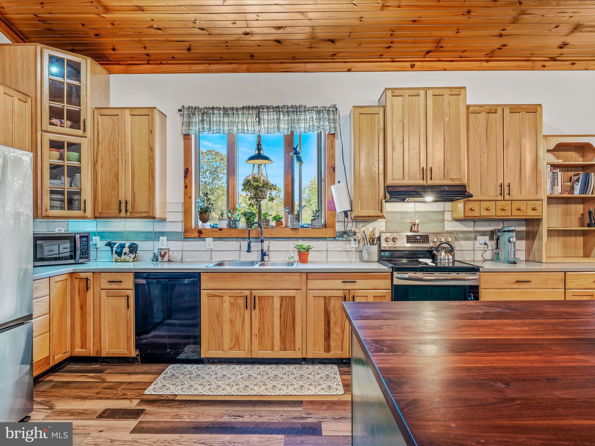 104 Golden Lane Berkeley Springs, WV 25411 - Photo 10 of 53 a kitchen with stainless steel appliances kitchen island granite countertop a sink stove and cabinets