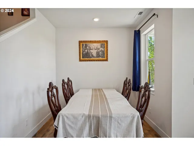 a view of a dining room with furniture and a window
