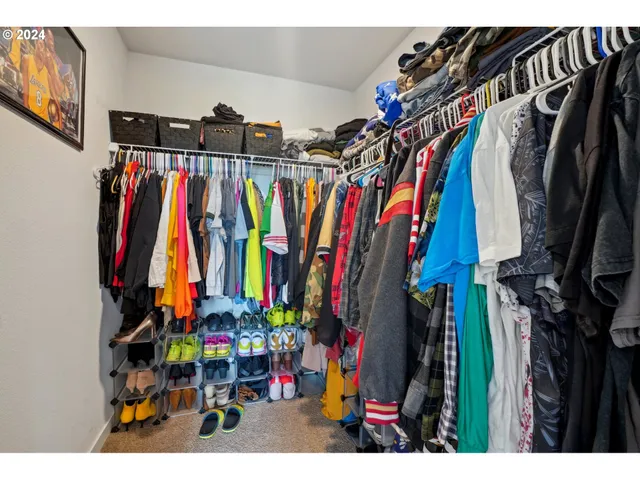 a view of walk in closet with clothes